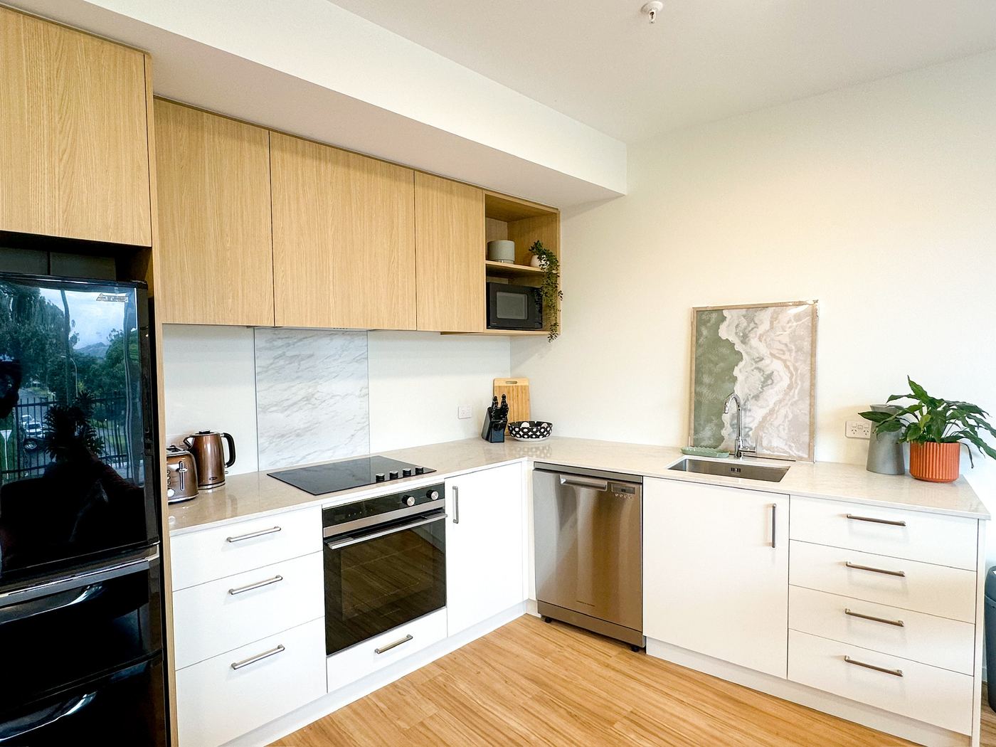 Kitchen with fridge-freezer, wall oven, stove and dishwasher