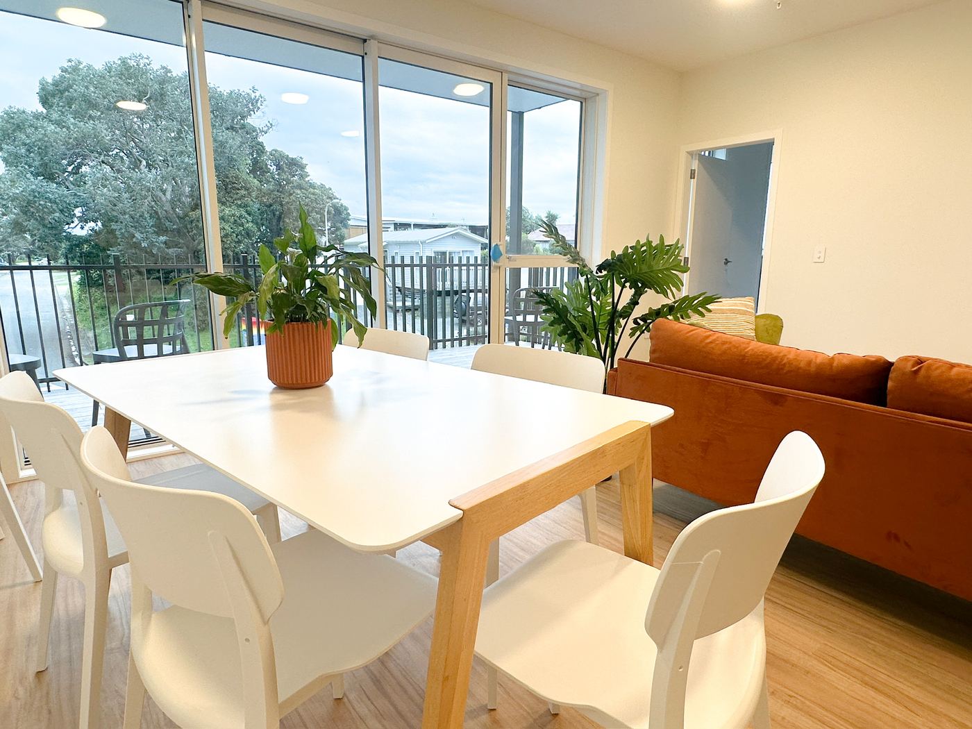 Dining table seating six with balcony view beyond
